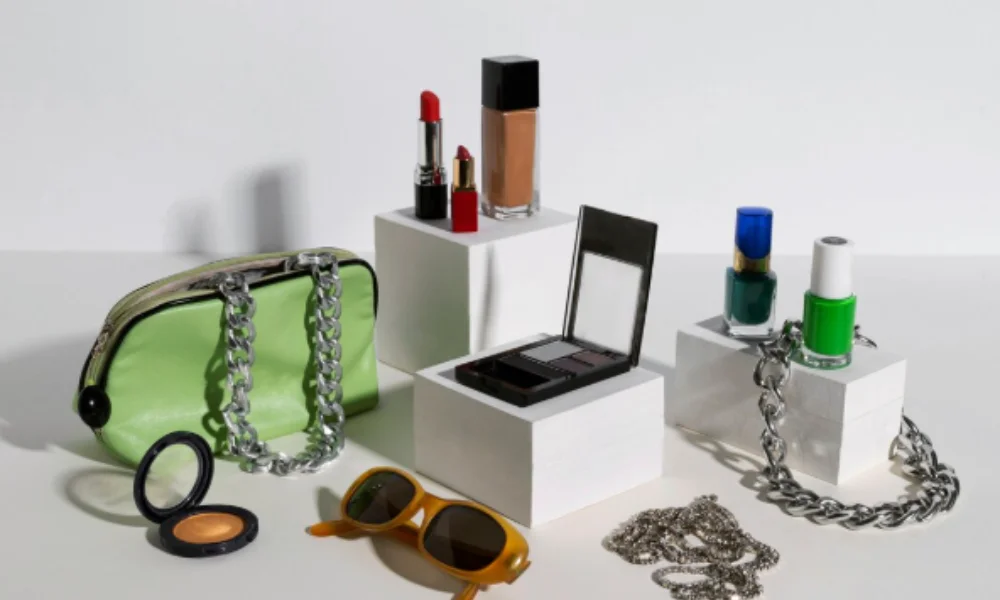 A stylish display of cosmetics and accessories, including lipstick, foundation, nail polish, eyeshadow-how to style luxury accessories