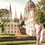 Couple walking past Hungarian Parliament building
