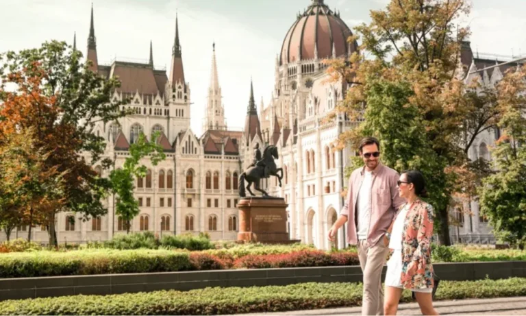 Couple walking past Hungarian Parliament building