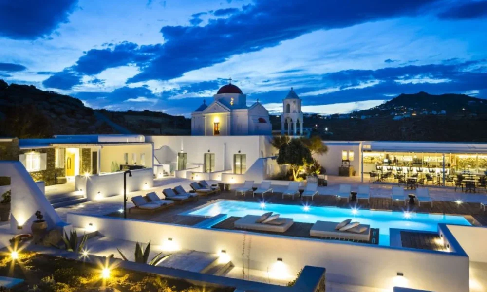 Eco Luxury Resorts resort with pool, church, and bar at dusk