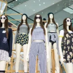 Five mannequins in trendy outfits, mall background