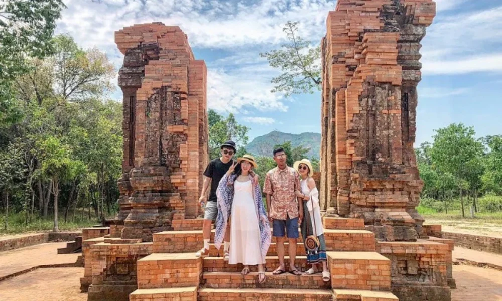 Four friends pose at ancient brick ruins