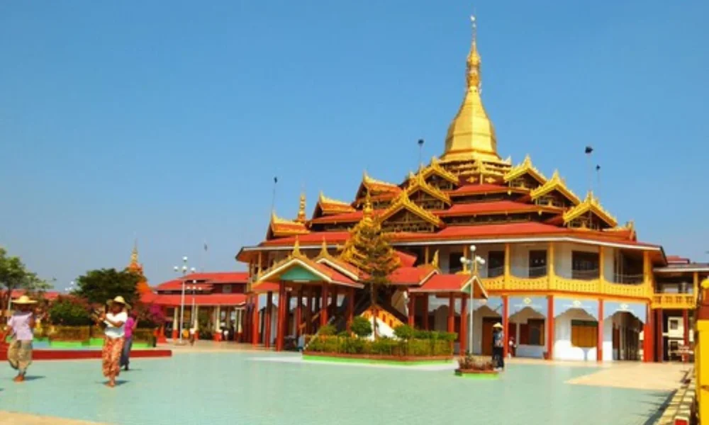 Golden pagoda with red roofs, people walking