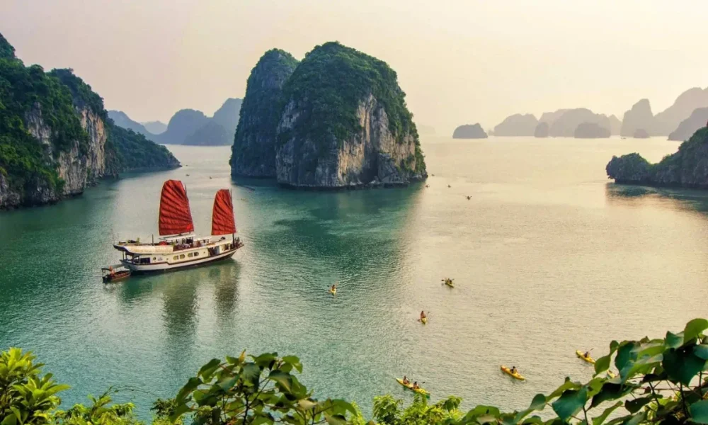 Ha Long Bay with a junk boat and kayakers