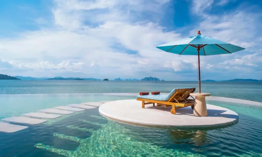 Infinity pool with lounge chair and umbrella