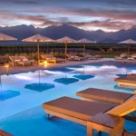 Luxury travel South America poolside loungers at sunset with mountain views