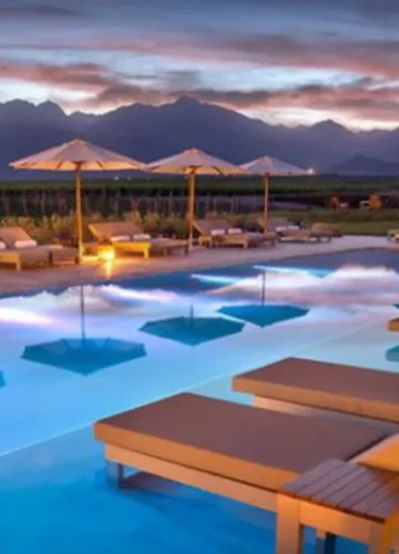 Luxury travel South America poolside loungers at sunset with mountain views