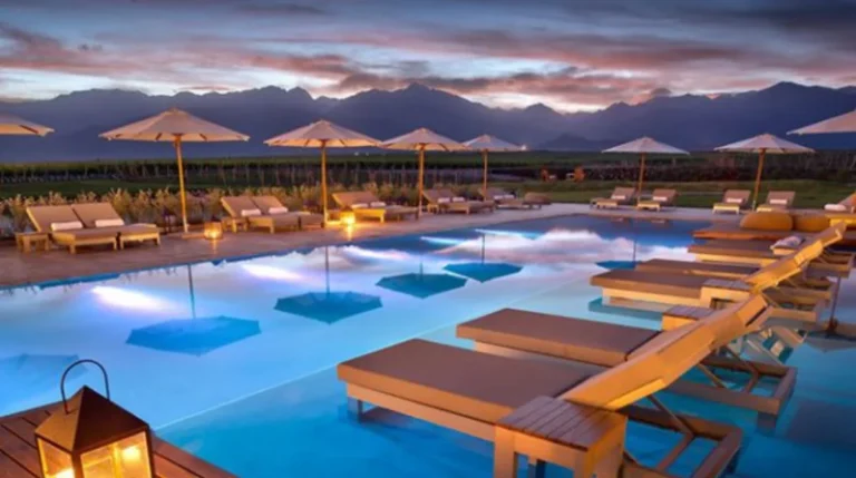 Luxury travel South America poolside loungers at sunset with mountain views
