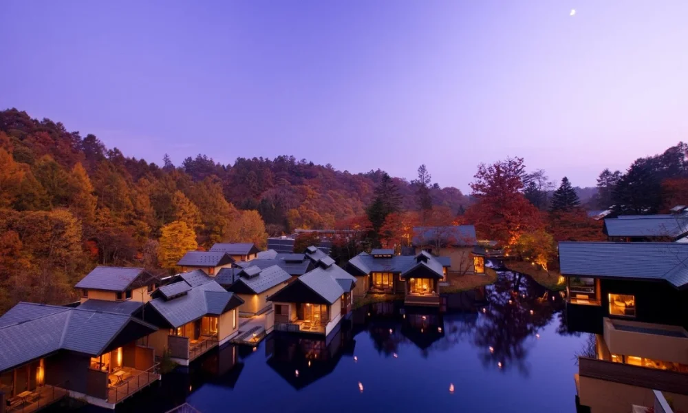 resort cabins on water autumn trees moonlit sky