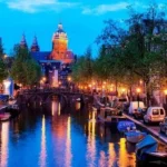 Amsterdam canal at dusk, glowing lights