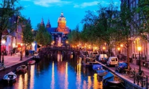 Amsterdam canal at dusk, glowing lights
