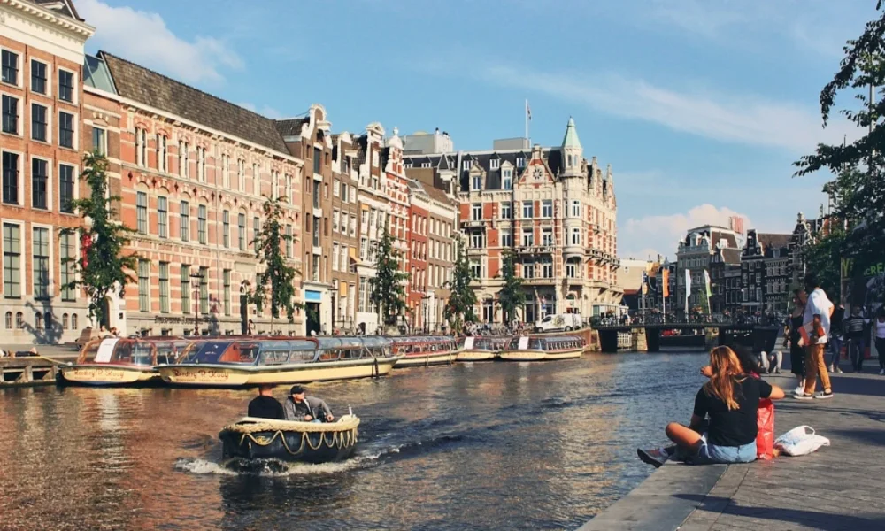 Amsterdam canal with boats and people