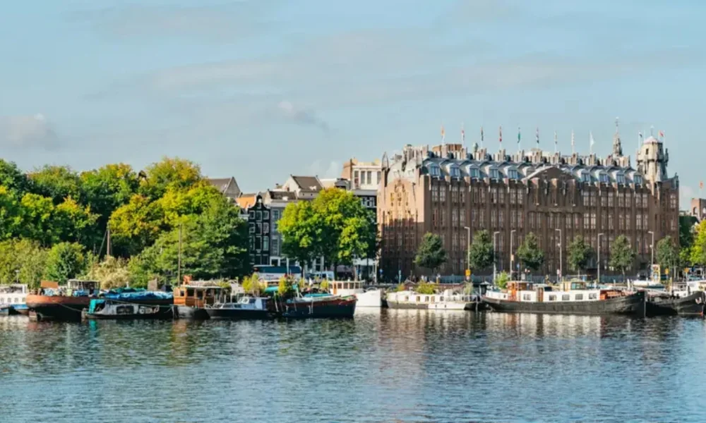 Boats on a canal with buildings and trees