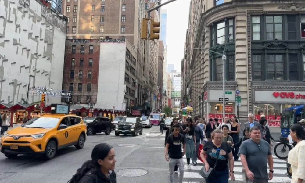 Busy New York City street with pedestrians and yellow cabs