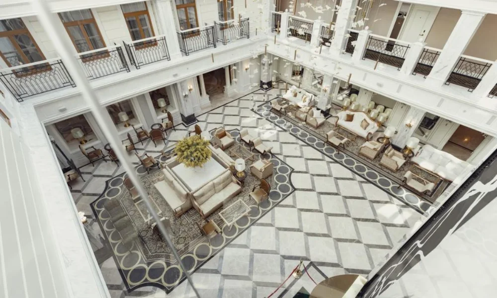 Grand hotel lobby with checkered floor, balconies
