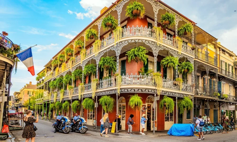new orleans street with ornate balconies ferns