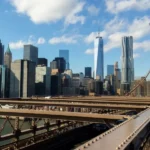 NYC skyline from Brooklyn Bridge on sunny day