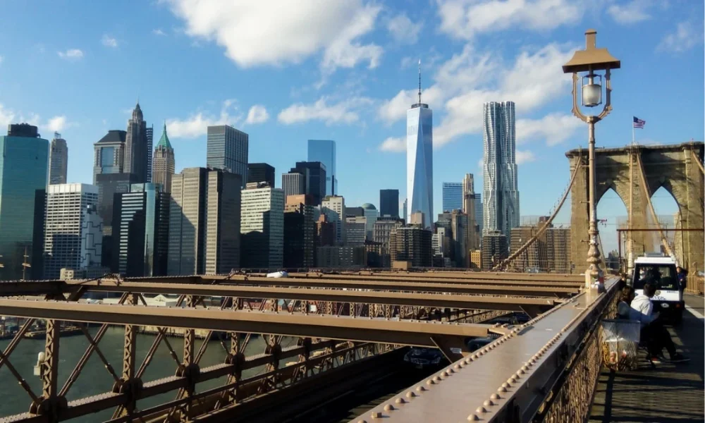 NYC skyline from Brooklyn Bridge on sunny day