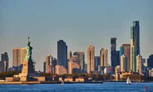 Statue of Liberty, NYC skyline, sailboats on water