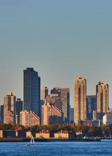 Statue of Liberty, NYC skyline, sailboats on water