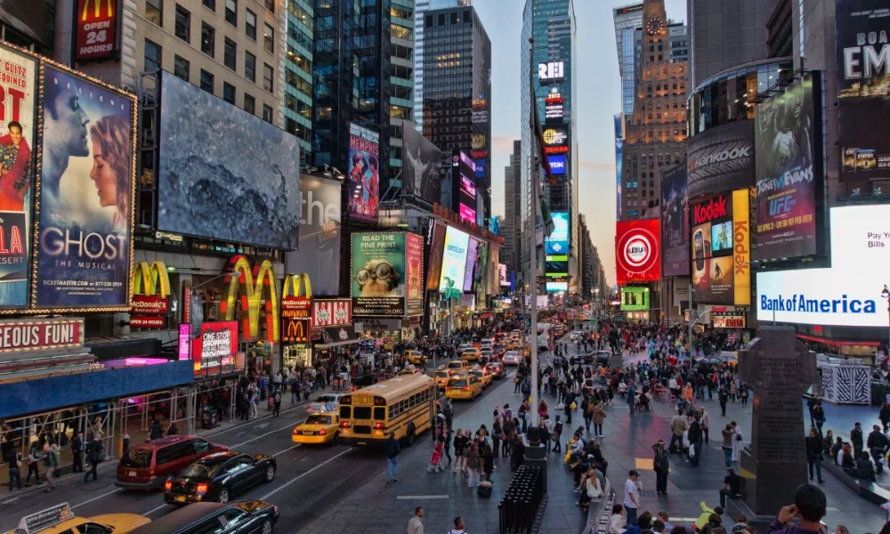 Times Square with bright billboards, crowds, and traffic