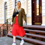 Blonde woman in plaid blazer and red skirt