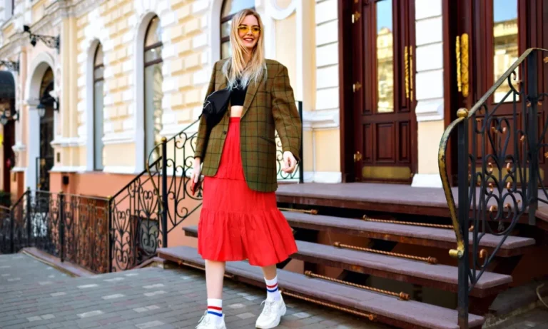 Blonde woman in plaid blazer and red skirt