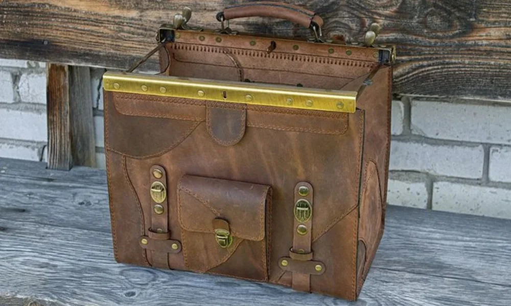 Brown leather satchel with brass accents