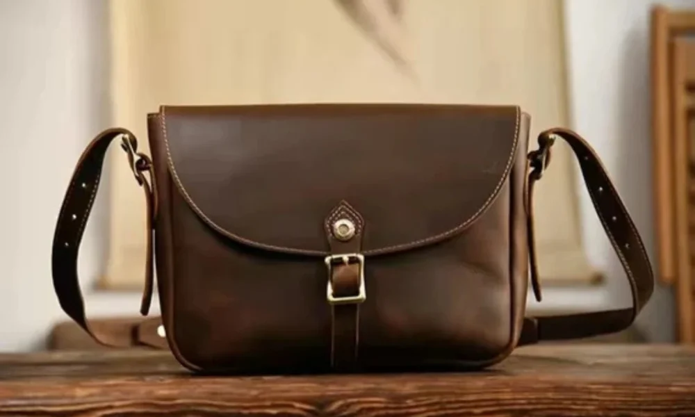 Brown leather satchel with brass buckle