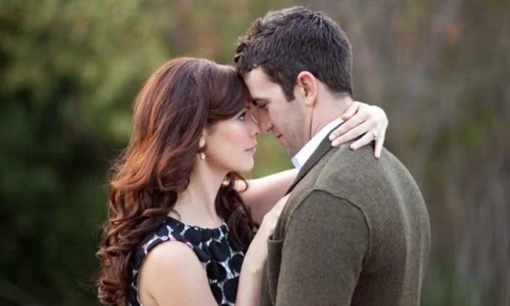 Couple embracing, foreheads touching, looking at each other.