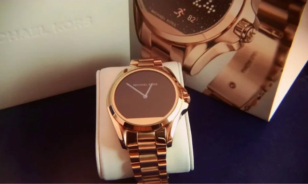 Rose gold Michael Kors smartwatch on stand