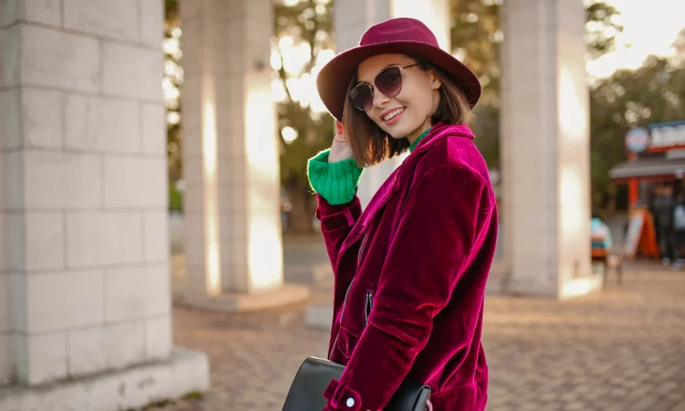 Smiling woman in velvet jacket and hat