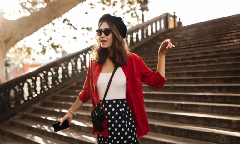 Woman in red shirt, polka dot skirt on stairs