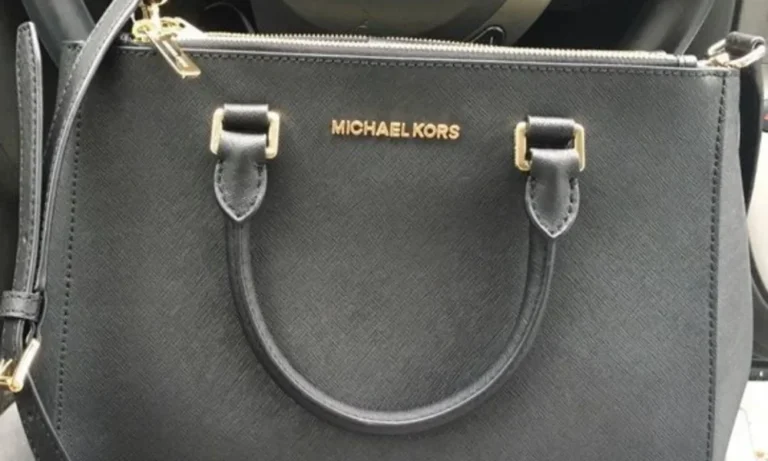 Black Michael Kors handbag with gold lettering