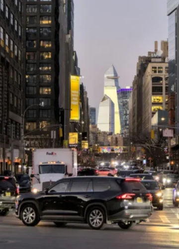 Busy city street with cars and tall buildings