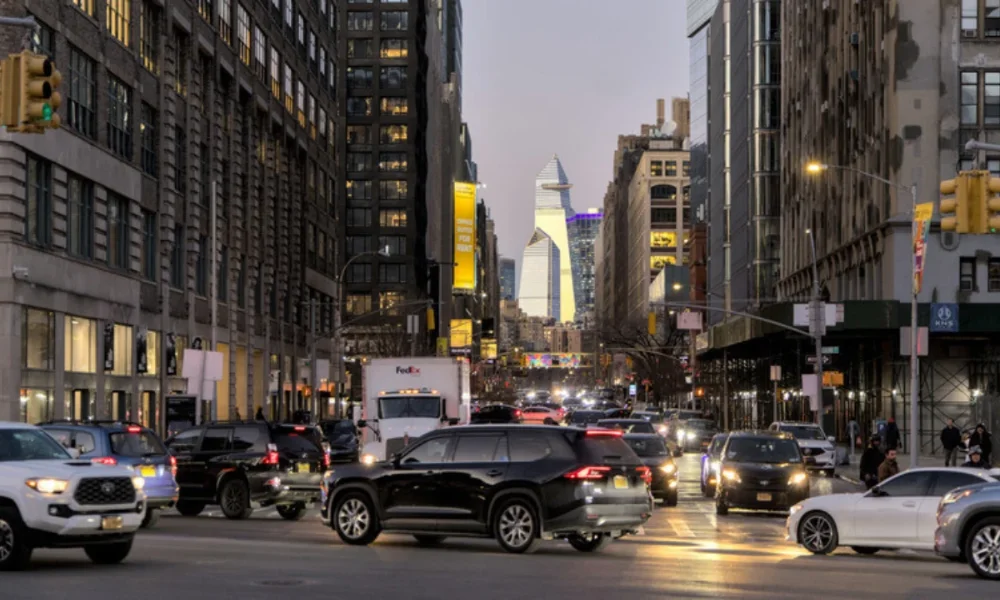 Busy city street with cars and tall buildings