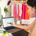 Fashion designer sketching on laptop