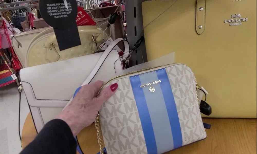 Hand holding Michael Kors purse in store