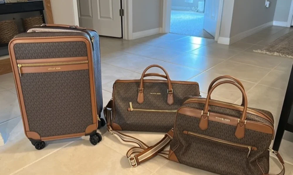 Michael Kors luggage set on tiled floor