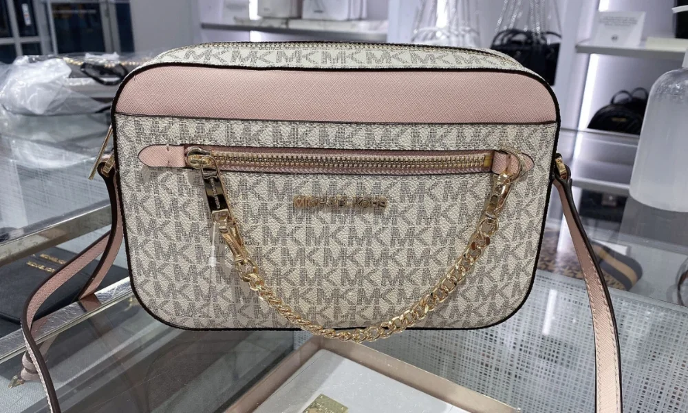 Michael Kors monogram bag, pink top, gold chain