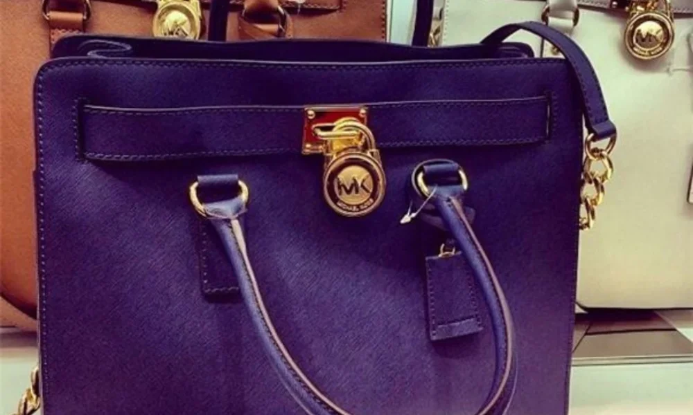 Navy blue Michael Kors handbag with gold hardware
