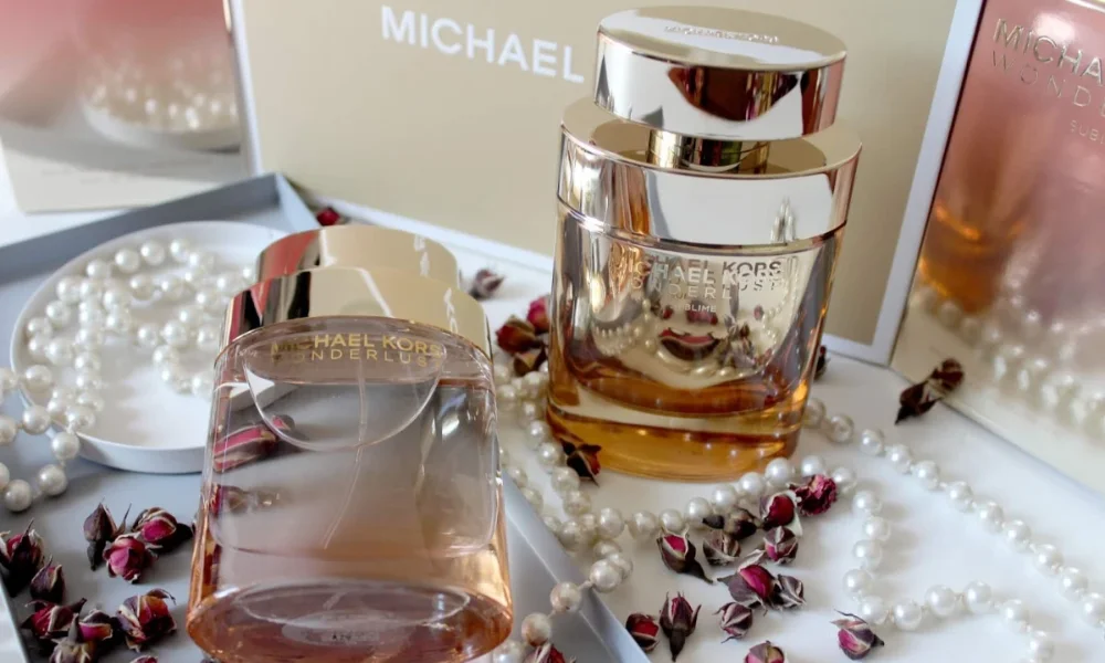 Two Michael Kors perfumes, pearls, and dried rosebuds