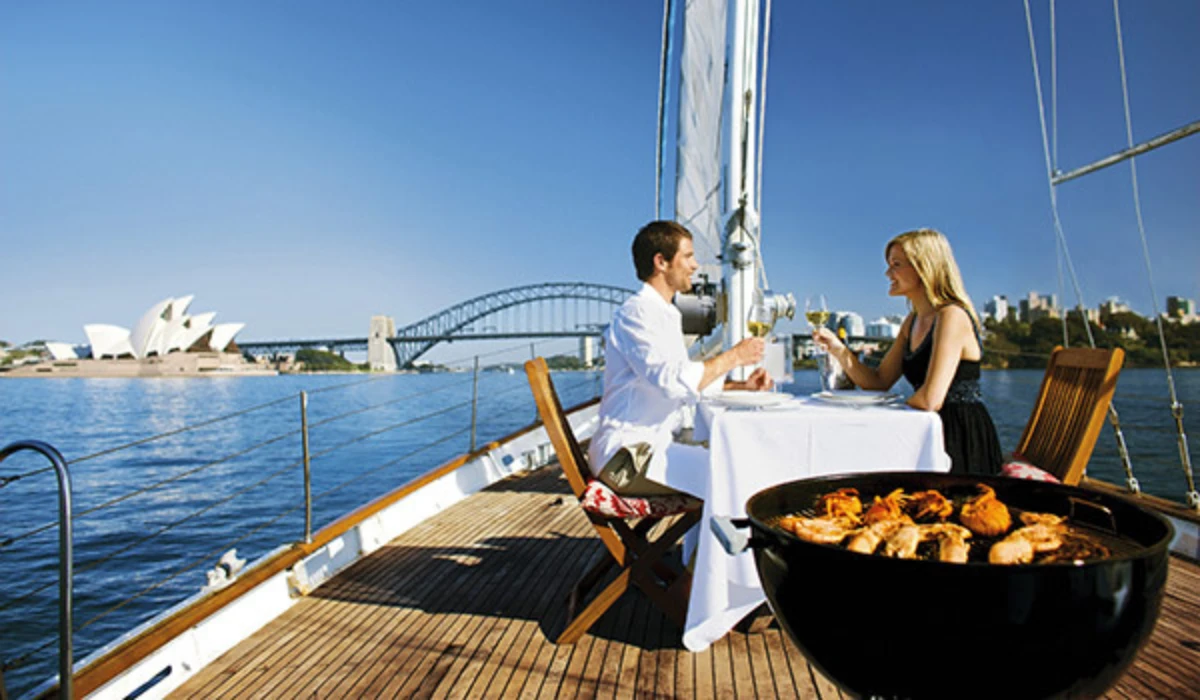 Couple dining on yacht with Sydney Opera House view