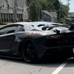 black lamborghini aventador svj on road