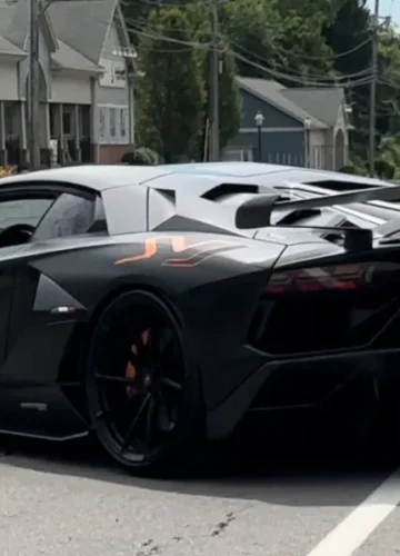 black lamborghini aventador svj on road