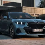 Blue BMW parked in front of a modern house