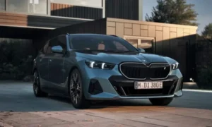 Blue BMW parked in front of a modern house