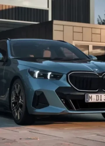 Blue BMW parked in front of a modern house