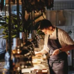 Chef plating food in a modern kitchen