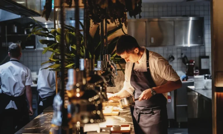 Chef plating food in a modern kitchen